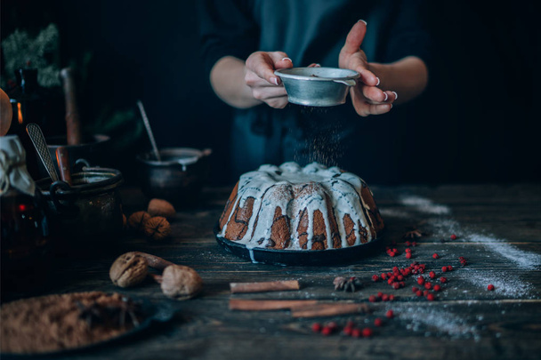 Christmas magic time. Dark baking background with ingredients, holiday natural decorations and utensils. Merry Christmas and Happy Holidays. Family preparation holiday food.  - Foto, imagen