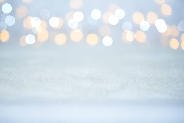 Magic twinkling holiday abstract glitter background with blinking lights and snow. Blurred bokeh of Christmas lights. - Photo, image