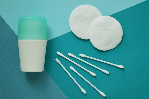 Cotton pads for face and buds for ears, deodorant on blue background. - Φωτογραφία, εικόνα