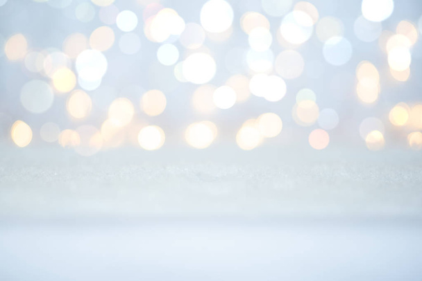 Snow and lights. Empty space white snowy table. Christmas card. - Zdjęcie, obraz
