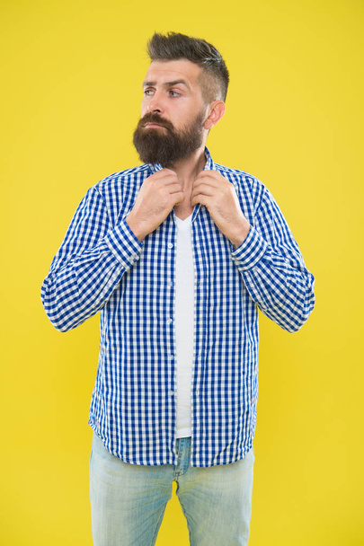 Mature man expressing interest. Summer hipster grooming. Male fashion and spring style. Brutal bearded hipster in checkered shirt. surprised man with beard on yellow background. morning grooming - Fotoğraf, Görsel