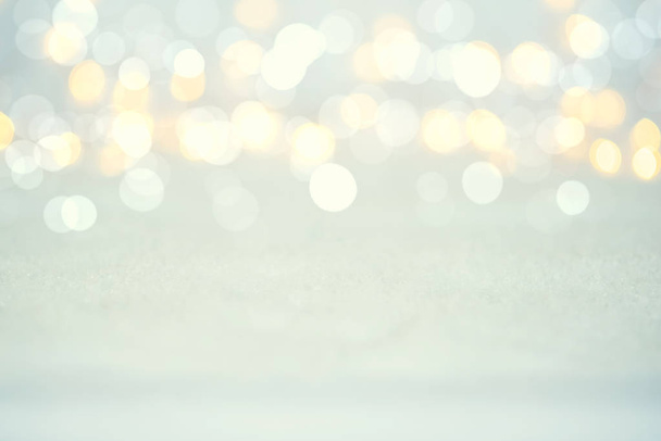 Magic twinkling holiday abstract glitter background with blinking lights and snow. Blurred bokeh of Christmas lights. - Fotó, kép