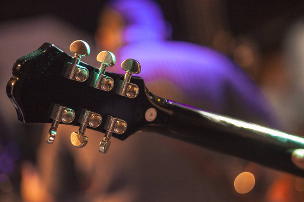 Palette of a guitar at a night concert - Foto, Imagen