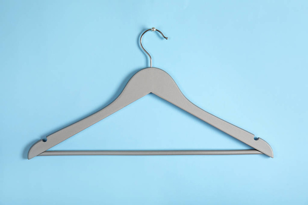 Empty clothes hanger on color background. Wardrobe accessory - Photo, Image
