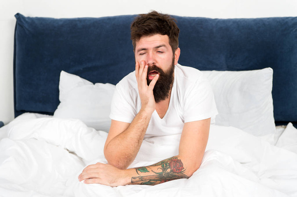 Overworked. brutal sleepy man in bedroom. bearded man hipster sleep in morning. asleep and awake. mature male with beard in pajama on bed. energy and tiredness. tired man feeling overworked - Fotoğraf, Görsel