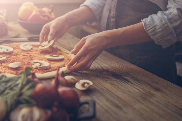 Pizza art. The process of making pizza. Raw dough for pizza with ingredients and spices on table. Traditional Italian pizza and vegetables on a dark wooden background. Pizza menu. Soft focus. - Foto, immagini