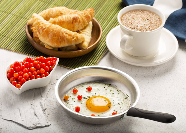 Breakfast with fried egg, croissant and hot chocolate drink. Top view - Photo, Image