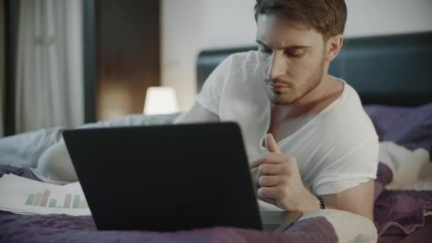 Casual man working online on laptop computer at home. Serious man work notebook - Video, Çekim