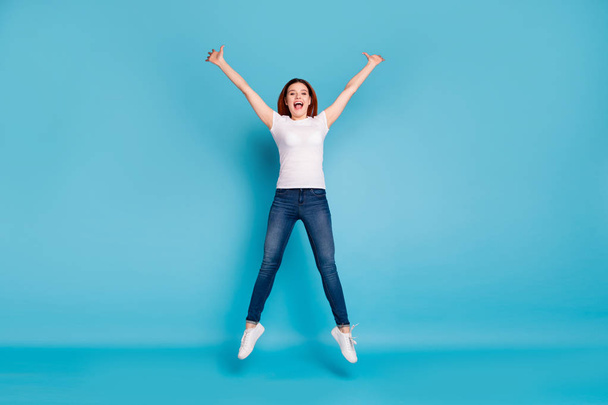 Full length body size view portrait of her she nice attractive lovely cheerful cheery girlish girl wearing white tshirt having fun time isolated over bright vivid shine blue background - Foto, Imagen