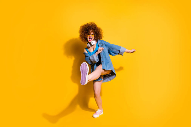 Full length body size photo funny she her lady wavy styling curls clubber strange moves wear headset ear flaps specs casual jeans denim shirt shorts tank top clothes isolated yellow background - Photo, Image