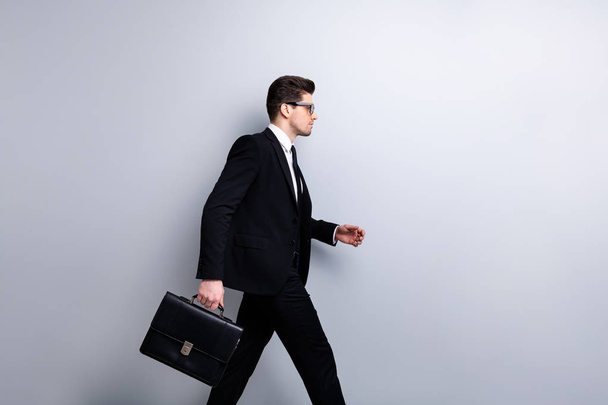 Profile side view portrait of his he nice elegant classy chic attractive guy carrying in hands diplomat attorney lawyer marketing sales manager coach training isolated over light gray background - Foto, Imagem