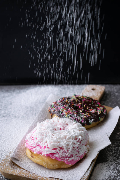 Donut with chocolate glazed and strawberry glazed in wooden tray - Foto, afbeelding