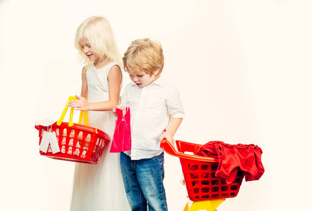 Couple kids hold plastic shopping basket toy. Kids store. Mall shopping. Buy with discount. Buy products. Play shop game. Cute buyer customer client hold shopping cart. Girl and boy children shopping - Фото, зображення