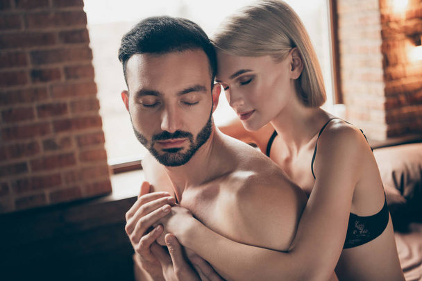 Close up side profile photo two people partners she her lady eyes closed whisper ear words touch hands him his handsome chest wife husband celebrate valentine day piggy back carry house room indoors - Photo, image