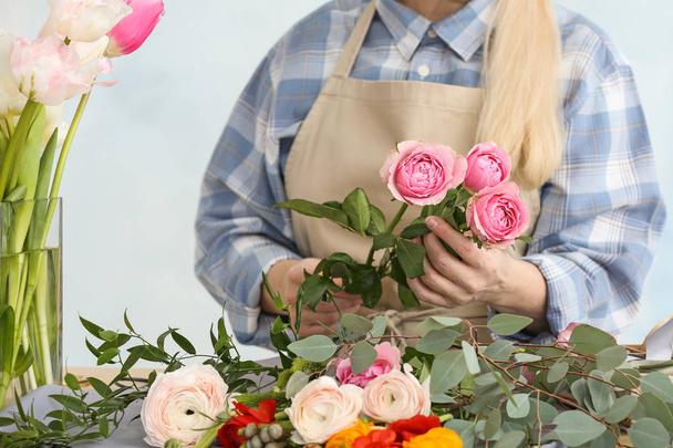 Florist making beautiful bouquet at table - Photo, Image