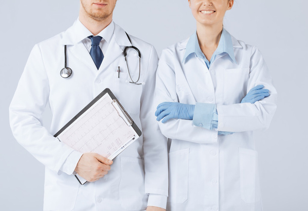 Nurse and male doctor holding cardiogram - Foto, imagen