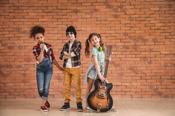 Band of little musicians against brick wall - Photo, Image