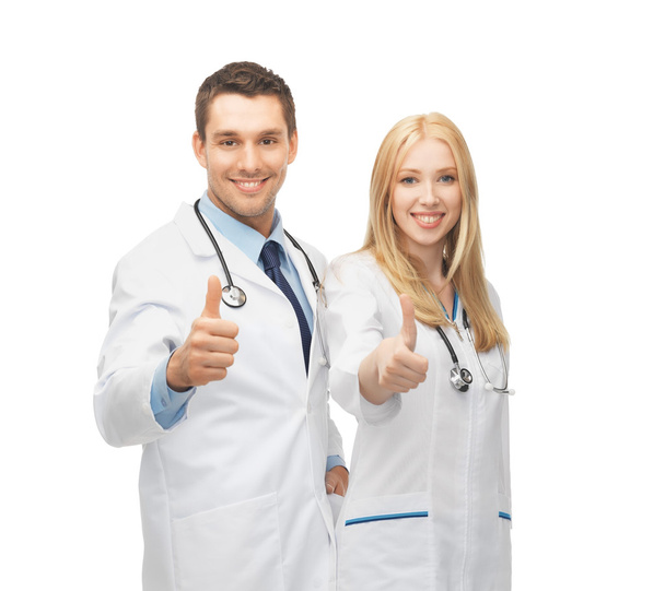 Jovem equipe de dois médicos mostrando polegares para cima
 - Foto, Imagem