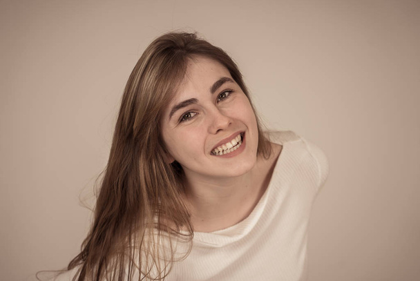 Portrait of cheerful young teenager woman with happy face smiling having fun posing and modeling. Studio shot isolated with copy space. In People, human emotions, youth happiness and beauty concept. - Foto, imagen