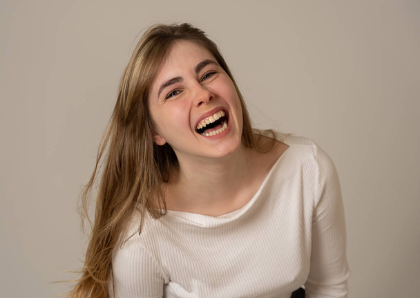 Portrait of cheerful young teenager woman with happy face smiling having fun posing and modeling. Studio shot isolated with copy space. In People, human emotions, youth happiness and beauty concept. - Zdjęcie, obraz