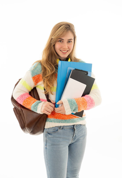 Portrait of beautiful teenager girl with backpack and notepad folder smiling against white background. Young college teen woman happy to start university. in People Education and student lifestyle. - Fotó, kép