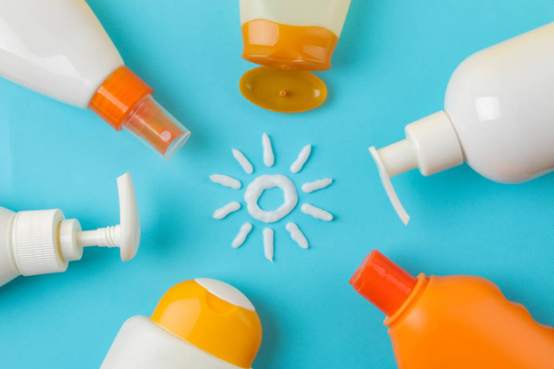 sunscreen remedy. various sunscreens and sun cream on a bright blue background. Sun protection. Ultraviolet protection. Summer. top view. - Photo, image