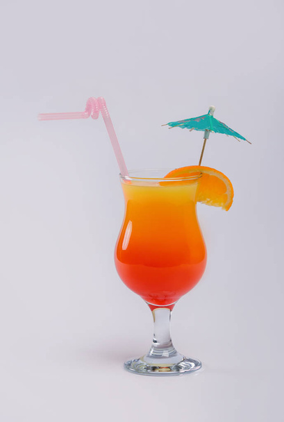 Alcoholic Fruit Drink. Fruit cocktail in a glass with a tube on a white background. Cocktail close-up of orange. - Foto, Imagem