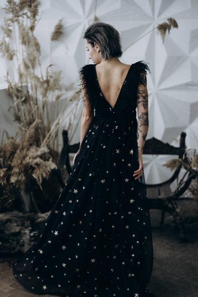 Full Length shot of stylish model posing in the studio weraing black dress - Valokuva, kuva