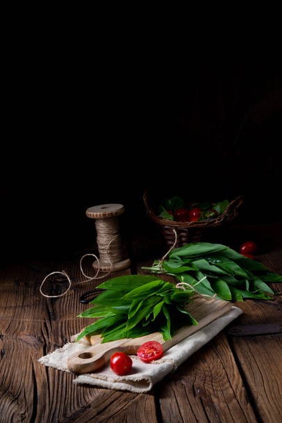 fresh green herbs and tomatoes on wooden table  - Фото, зображення