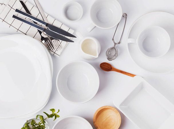 Different tableware and dishes on the white background, top view. - Zdjęcie, obraz