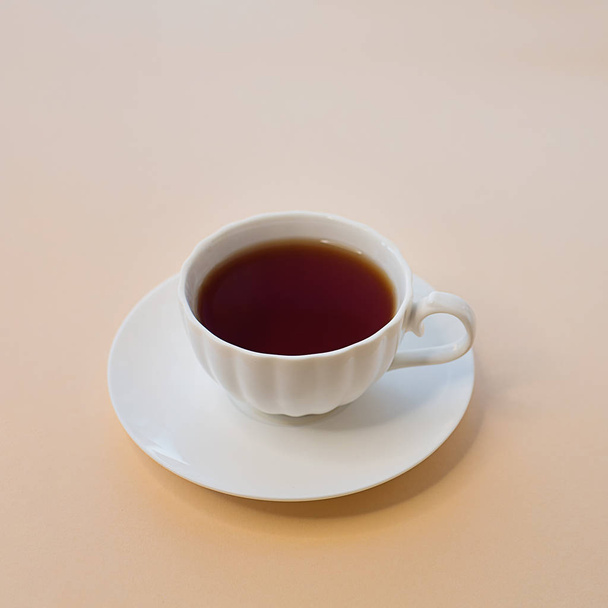Cup of tea on light square background - Fotó, kép