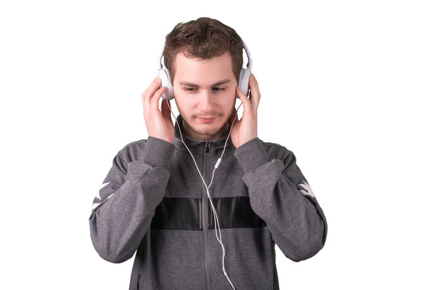 Handsome man listening music on white background - Photo, image
