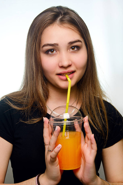 portrait of a girl with a cocktail in the Studio - Фото, изображение