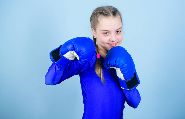 Female boxer change attitudes within sport. Feminism concept. With great power comes great responsibility. Boxer child in boxing gloves. Girl cute boxer on blue background. Rise of women boxers - Photo, Image