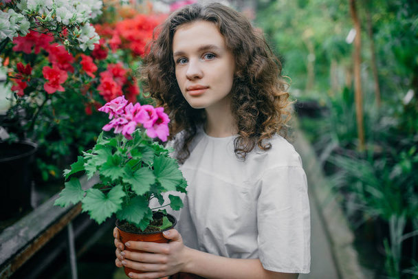 The young girl walks in a summer garden - Valokuva, kuva