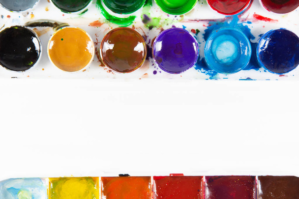 A set of children's paints in round, rectangular forms close-up. Copy space for text In frame - Foto, Bild