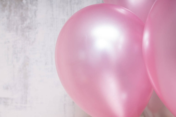 close up of bunch of silver and pink baloons on gray concrete background - Foto, immagini