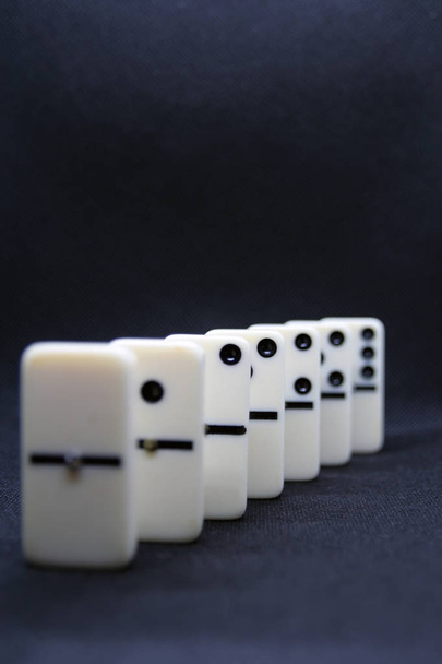 White marble dominoes on a black color background. - Photo, Image