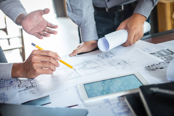 Construction engineering or architect discuss a blueprint while  - Foto, Imagem