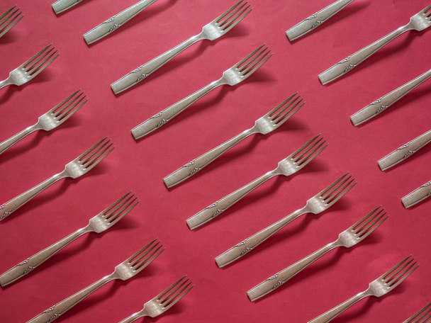 Silver forks pattern on red background - Foto, Imagem