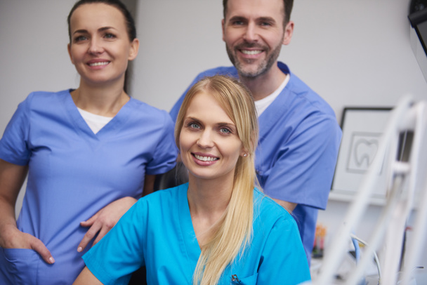 Equipo de dentistas sonrientes y satisfechos en el consultorio del dentista
 - Foto, imagen