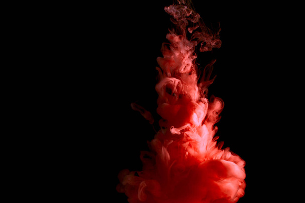 paint stream in water, colored ink cloud, abstract background, process of liquefaction red dye on a black background - Valokuva, kuva