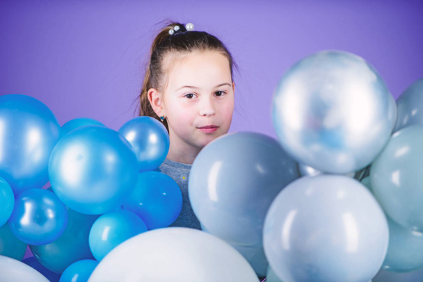 Birthday party. Childrens day. Carefree childhood. All those balloons for me. Happiness positive emotions. Obsessed with air balloons. Having fun. Balloons theme party. Girl between air balloons - Фото, изображение