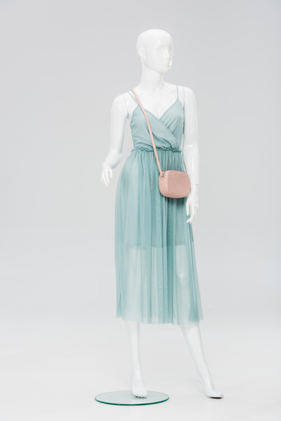 plastic mannequin with bag and dress isolated on grey  - Foto, Imagem