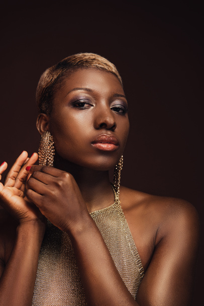 beautiful glamor african american woman with earrings isolated on brown - Photo, Image