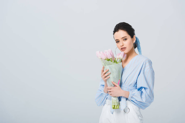 beautiful stylish girl with bouquet of tulips isolated on grey with copy space - Zdjęcie, obraz