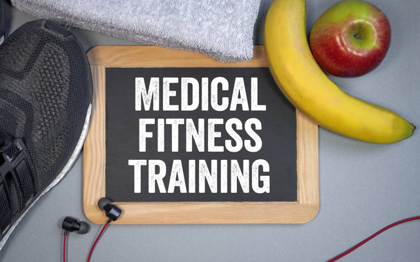 Chalkboard with the term medical fitness training with nutrition and sport shoes - Fotoğraf, Görsel