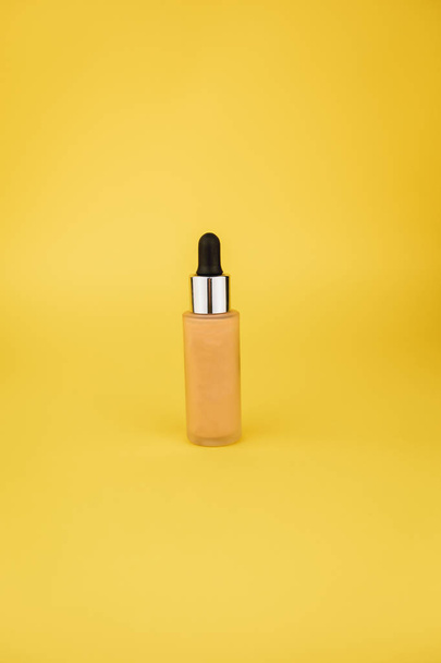 bottle with cosmetic serum on yellow background  - Fotoğraf, Görsel