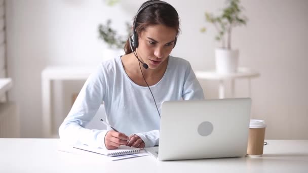 Young woman wearing headset learn foreign language using online course - Πλάνα, βίντεο