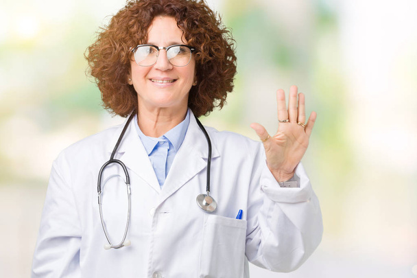 Middle ager senior doctor woman over isolated background showing and pointing up with fingers number five while smiling confident and happy. - Zdjęcie, obraz